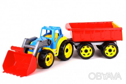 Яркий пластиковый трактор с ковшом спереди и прицепом сзади. Ковш на тракторе оп. . фото 1